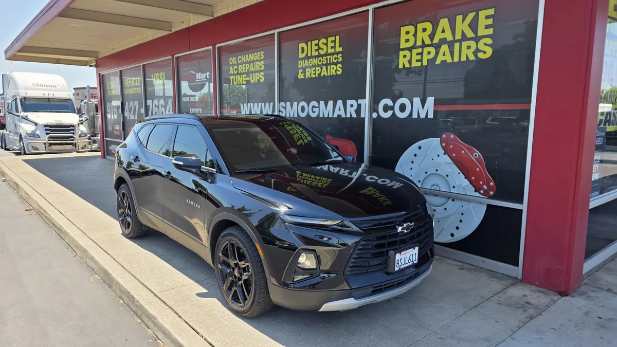 Chevy SUV in front of the Smog Mart service center