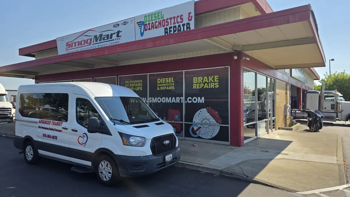 Commercial work van parked at Smog Mart for fleet service