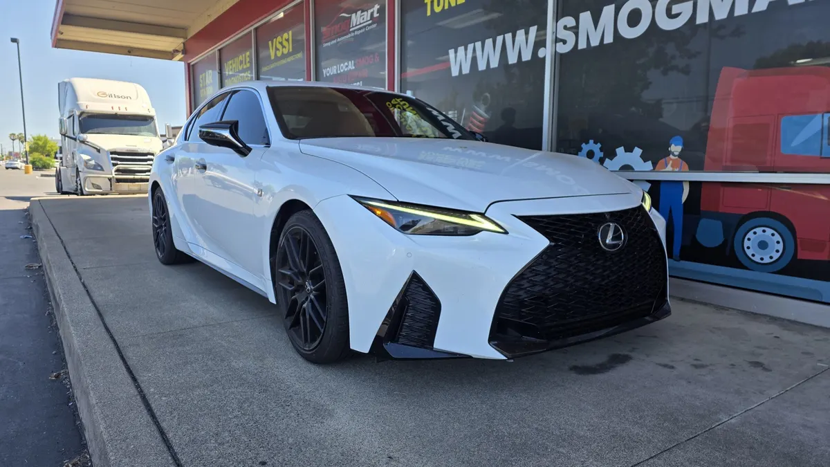 Lexus sedan in front of the Smog Mart service center