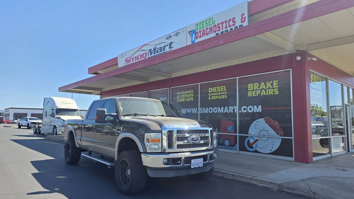 Ford Super Duty diesel truck parked outside Smog Mart