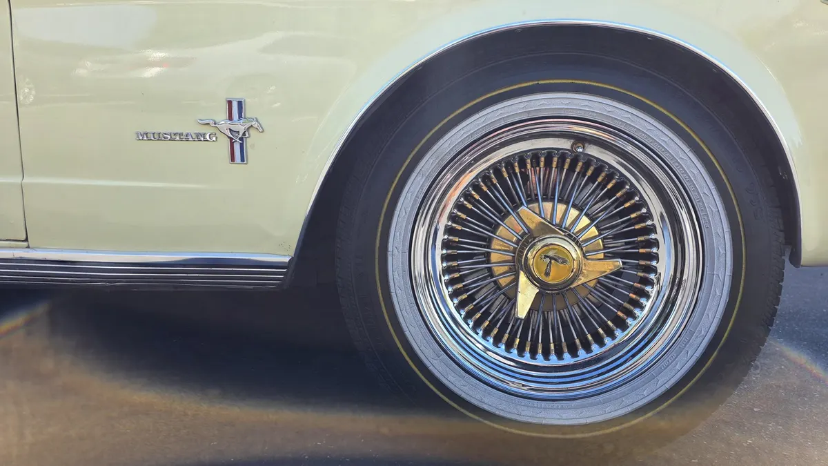Close-up of a wheel and brake at Smog Mart during a safety inspection
