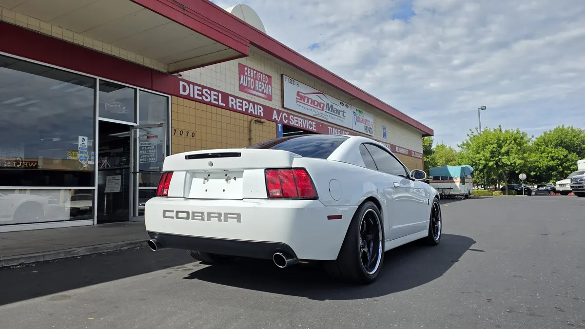 White Mustang parked at Smog Mart in Sacramento